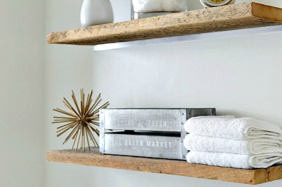 bathroom shelves with decor and towels on them