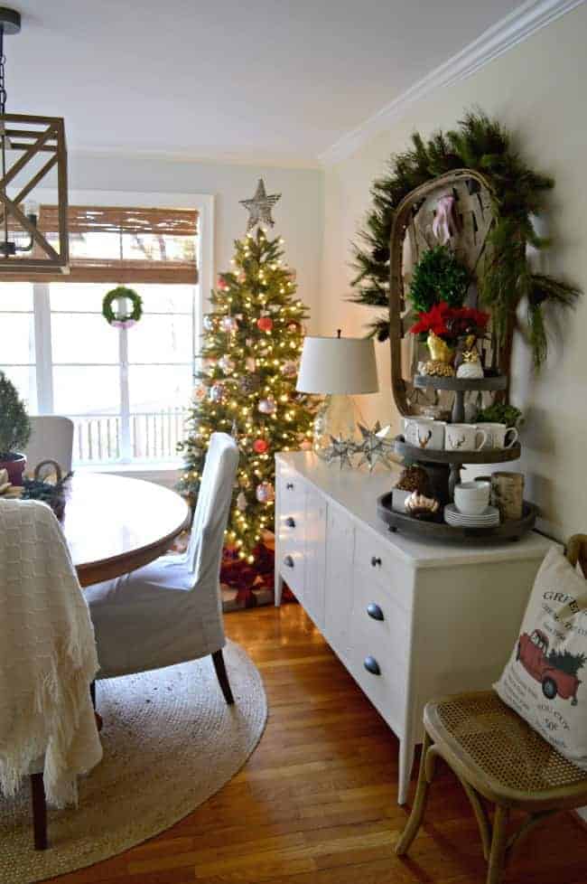 Christmas tree in corner of cottage dining room with white sideboard