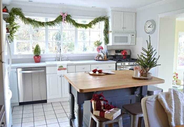 The kitchen in our rustic and simple cozy Christmas cottage decorated in red with touches of gold. www.chafieldcourt.com 