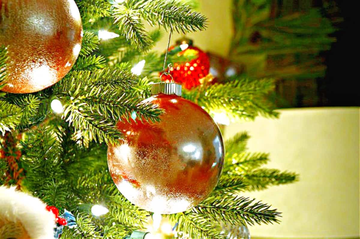 red mercury glass ornament hanging on Christmas tree