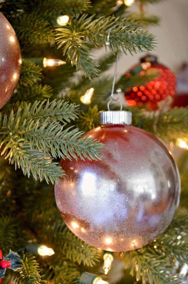 red mercury glass ornament hanging on Christmas tree