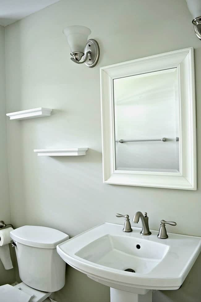 DIY Faux Floating Barn Wood Shelves small bathroom sink, mirror and empty shelves hanging on wall