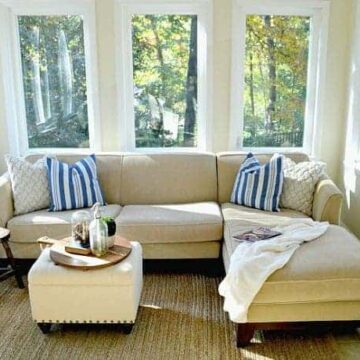 A sun room filled with furniture and a large window