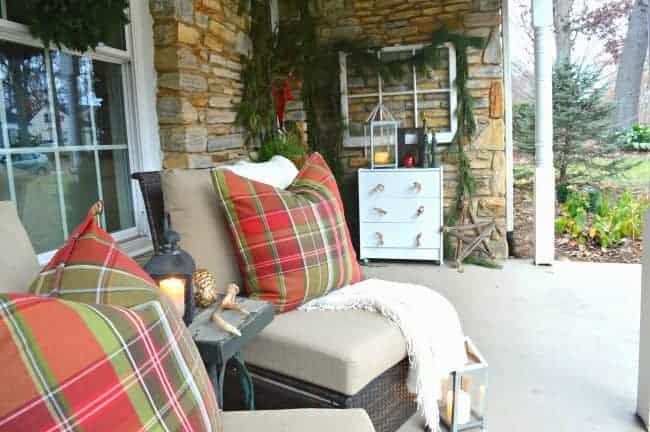 Decorating ideas for a cozy Christmas front porch using fresh garland, candles and a few rustic touches. www.chatfieldcourt.com 