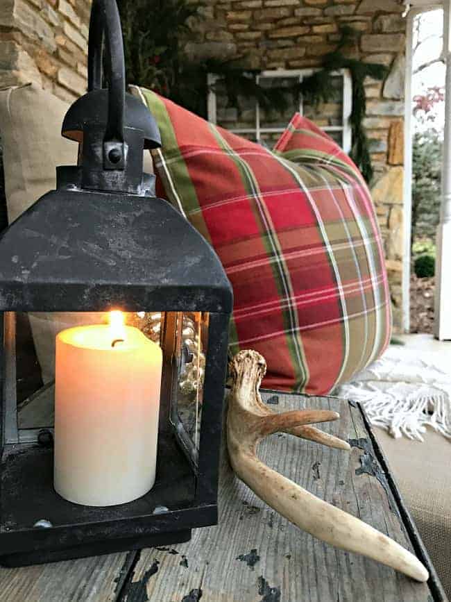 Decorating ideas to help you create a cozy Christmas porch using fresh garland, candles and a few rustic touches. www.chatfieldcourt.com 