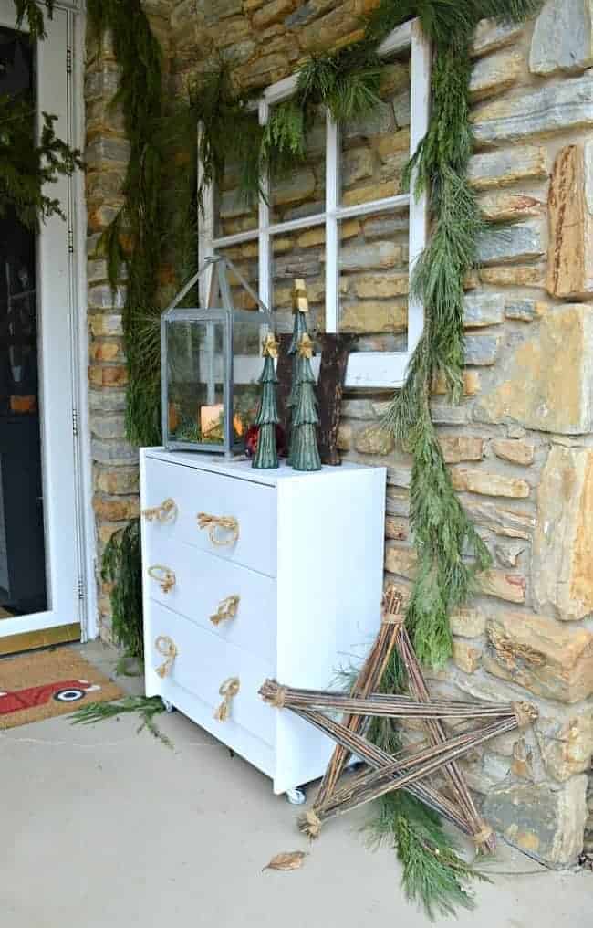 Decorating ideas for a cozy Christmas porch using fresh garland, lanterns, candles and a few rustic touches. www.chatfieldcourt.com 