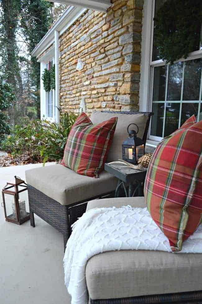 Decorating ideas to create a cozy Christmas porch using fresh garland, candles and a few rustic touches. www.chatfieldcourt.com 