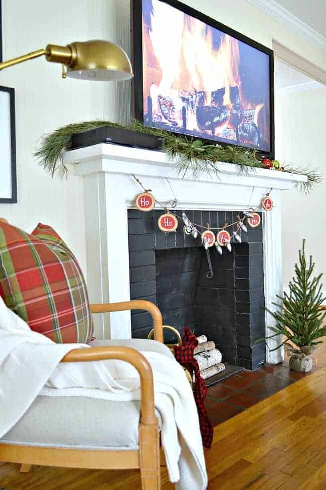 fireplace with tv decorated for Christmas