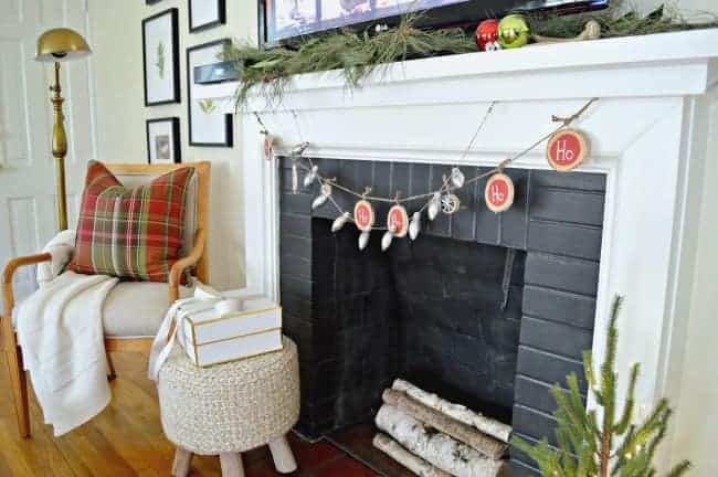 fireplace with white mantel decorated for Christmas with banners