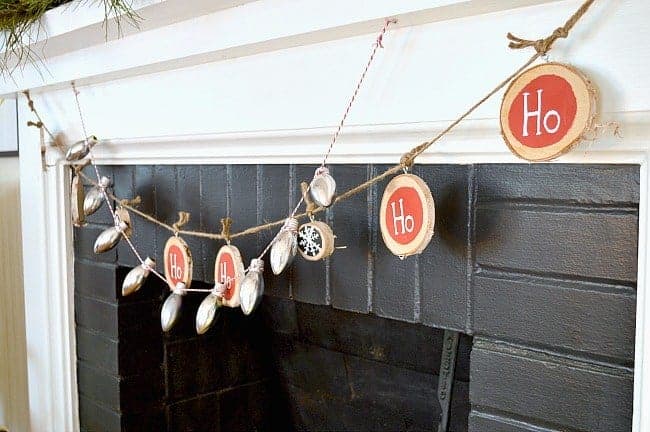 holiday banners hanging on a white fireplace mantel