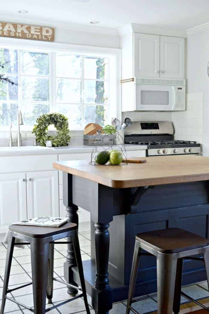 small kitchen and gray kitchen island with butcher block countertop