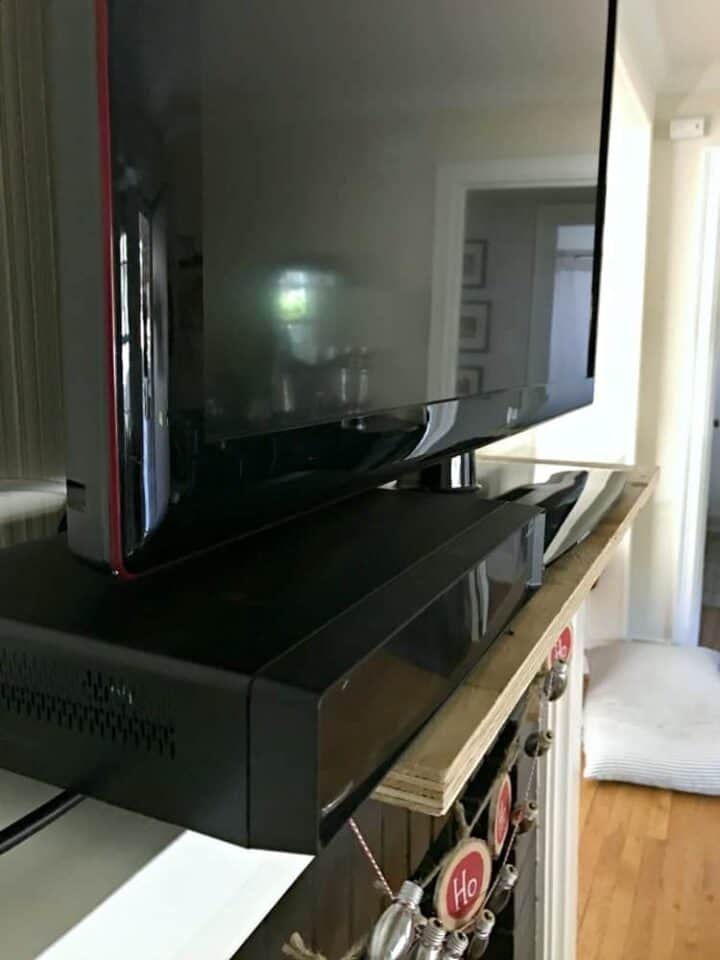 DIY Fireplace Mantel Makeover picture tv and cable box on fireplace mantel