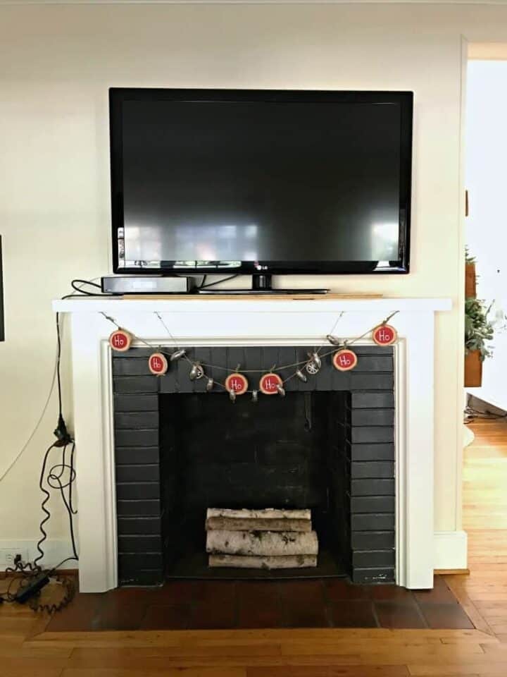 DIY Fireplace Mantel Makeover photo front view of tv on fireplace mantel