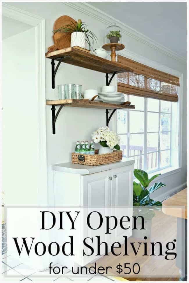 2 DIY barn wood shelves in a kitchen over a white kitchen cabinet. 