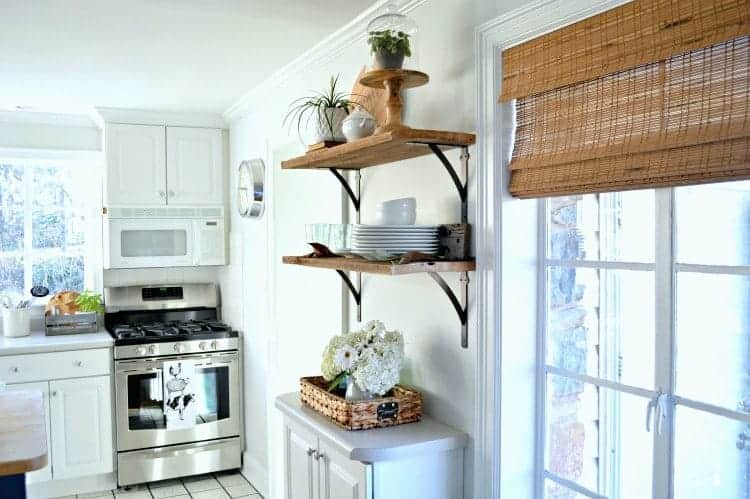 Beautiful DIY kitchen open shelving for under $50. A great way to add rustic, farmhouse charm instead of cabinets in the kitchen. www.chatfieldcourt.com