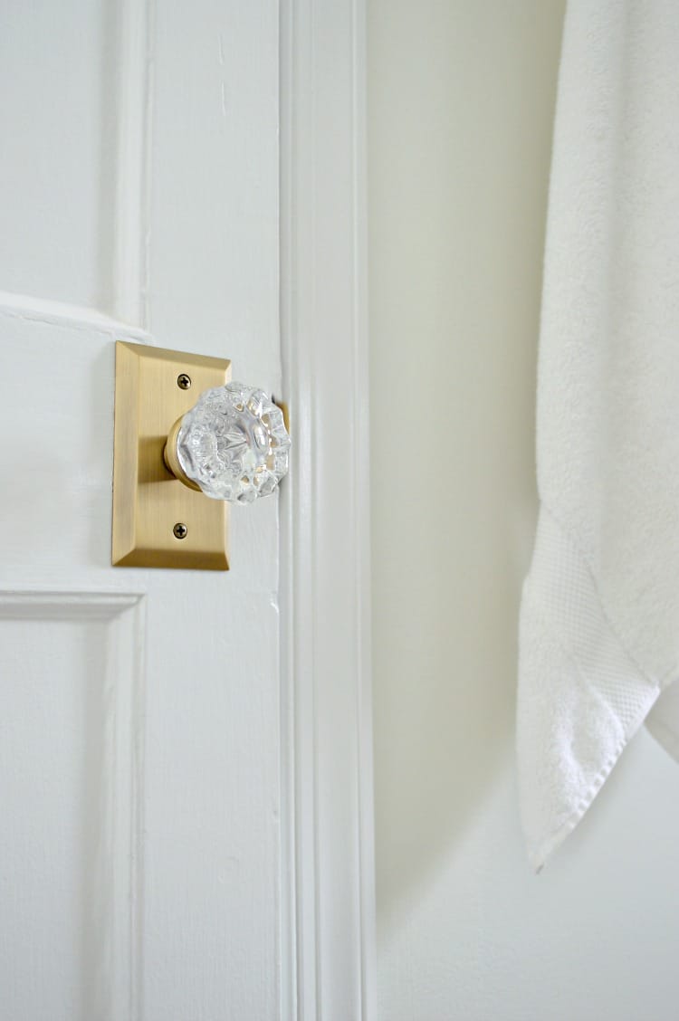 new brass and glass door knob on bathroom closet door