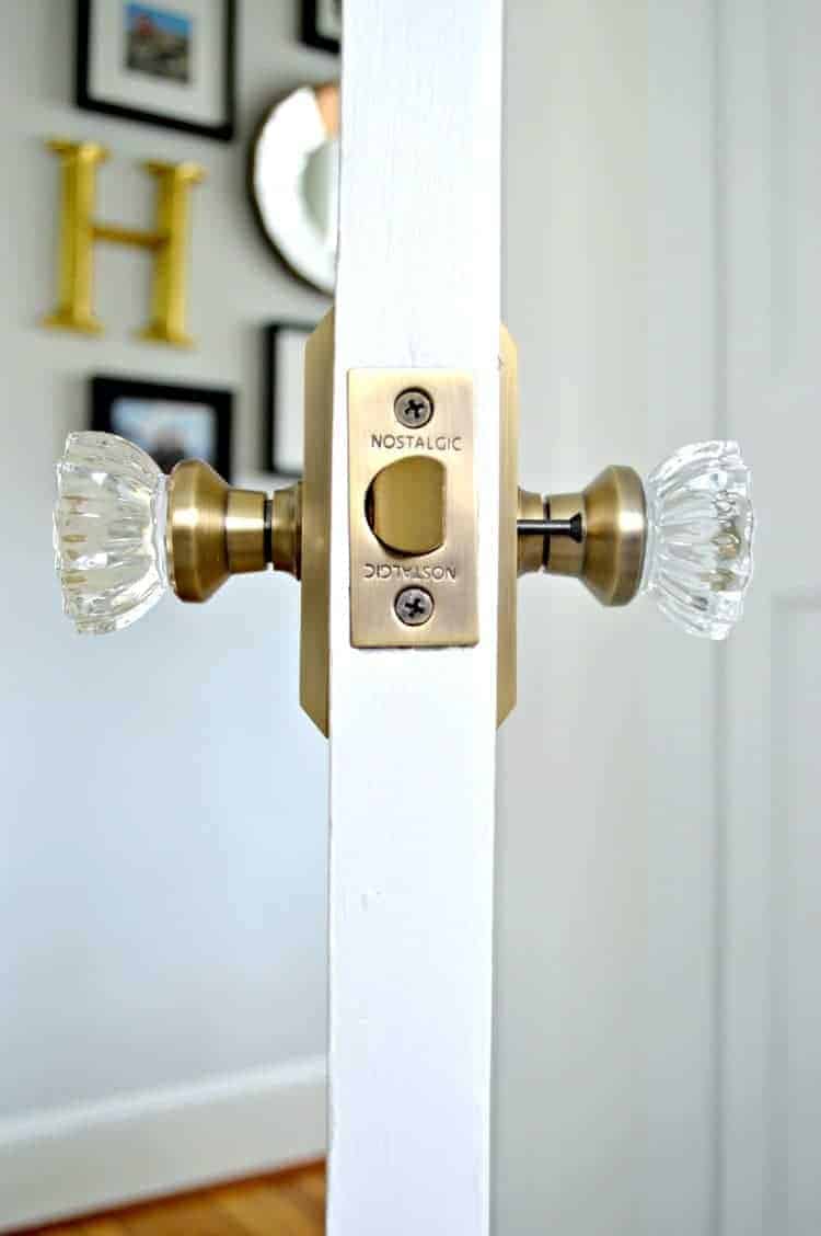 sideview of new brass and glass door knobs on bathroom door