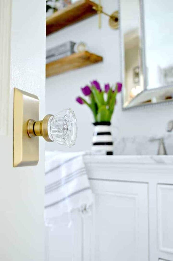 glass door knob on bathroom door with a peek in bathroom