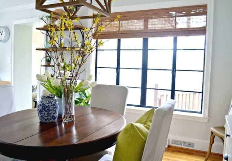 dining room round table in front of large painted black window