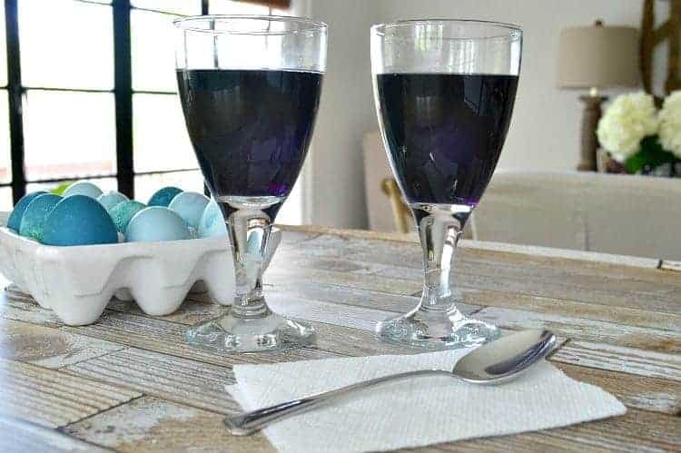2 glasses filled with natural food dye to color Easter eggs the natural way
