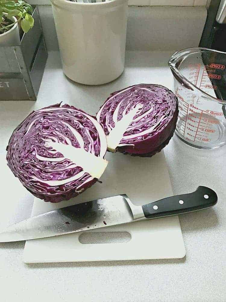 red cabbage cut in half on cutting board