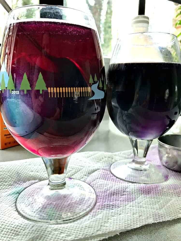 dyeing Easter eggs in a glass of natural food dye
