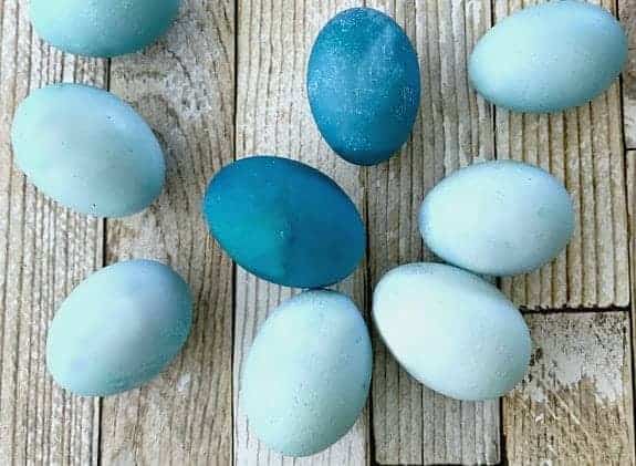 eggs dyed blue with red cabbage on wood planks