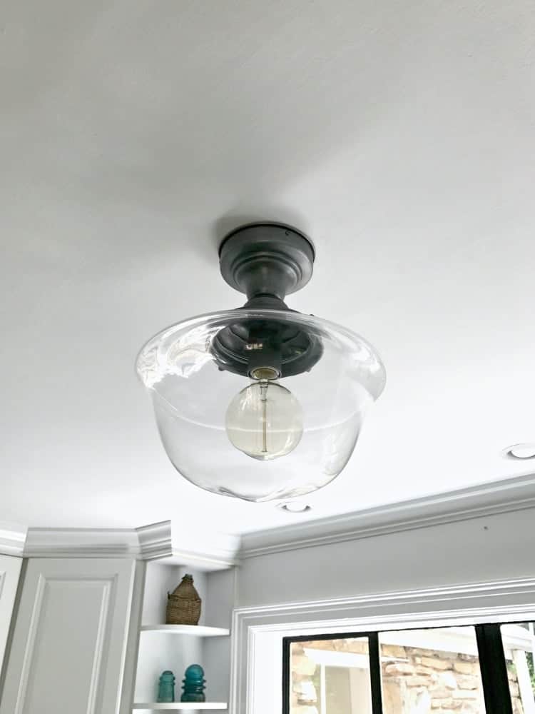 Installing a new kitchen ceiling light to add a bit of farmhouse charm to a small space. | Chatfield Court