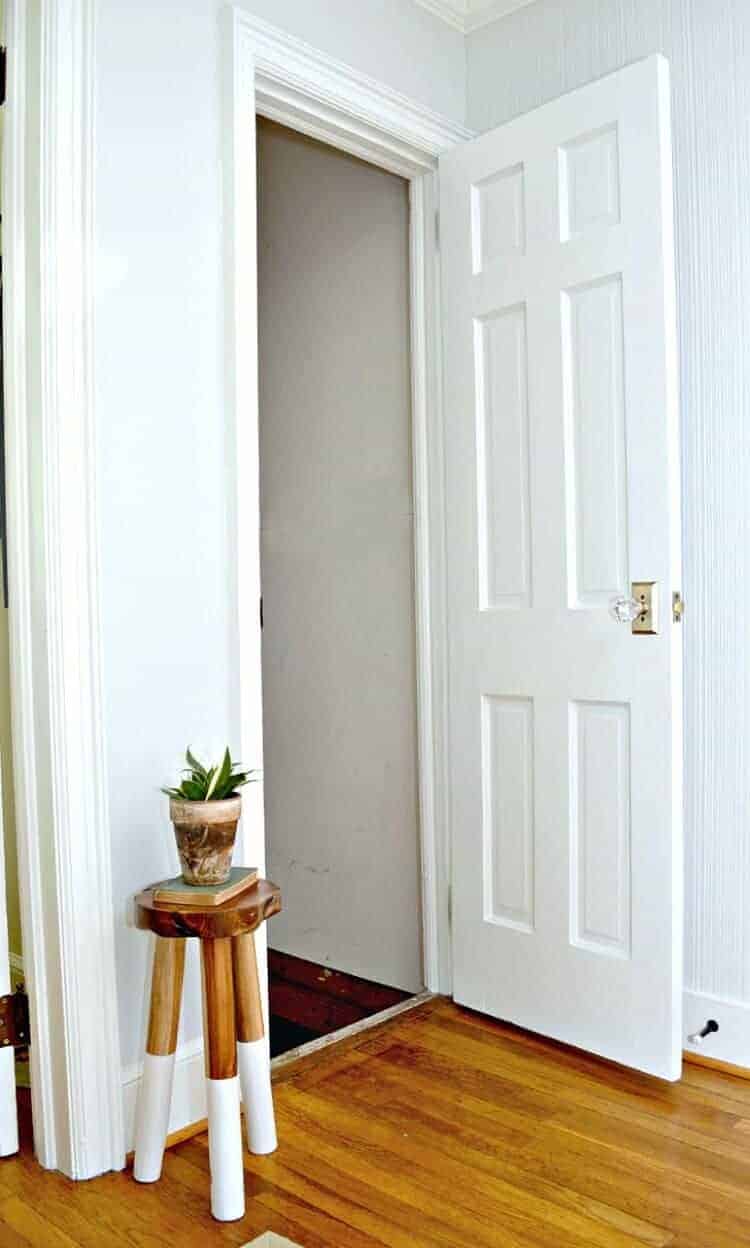 Changing out an old dirty basement door, with a cat door in it, for a freshly painted door found in the basement. 