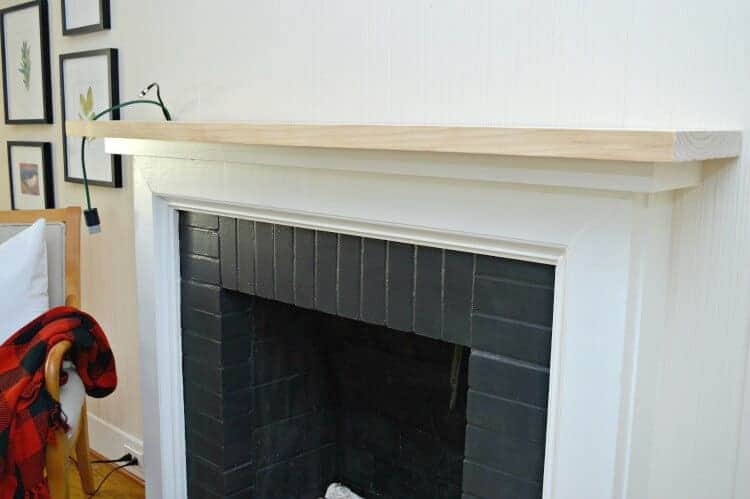 Beefing up a skimpy fireplace mantel with a piece of chunky, painted pine. 