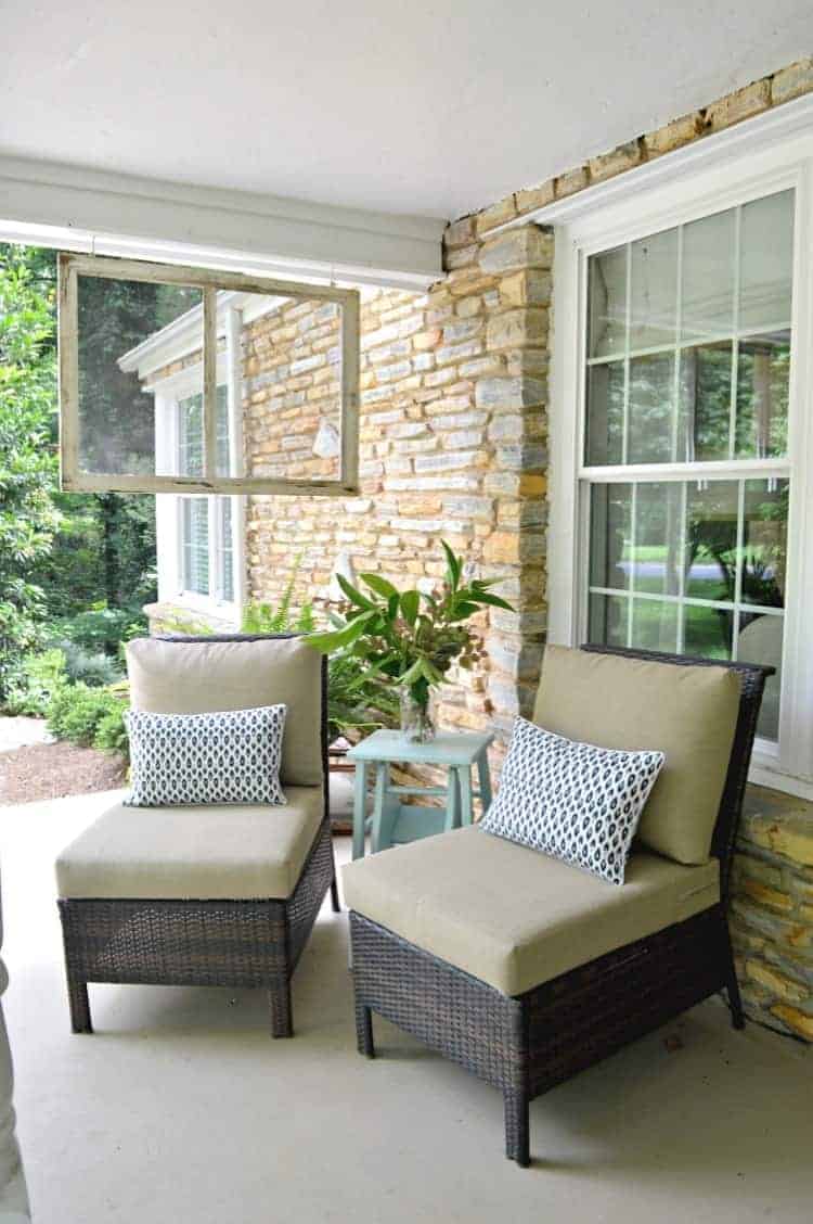 Finding new uses for an old thrifted window screen, like using it as a divider on a front porch.