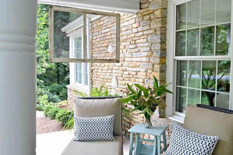 A front porch filled with furniture and a large window