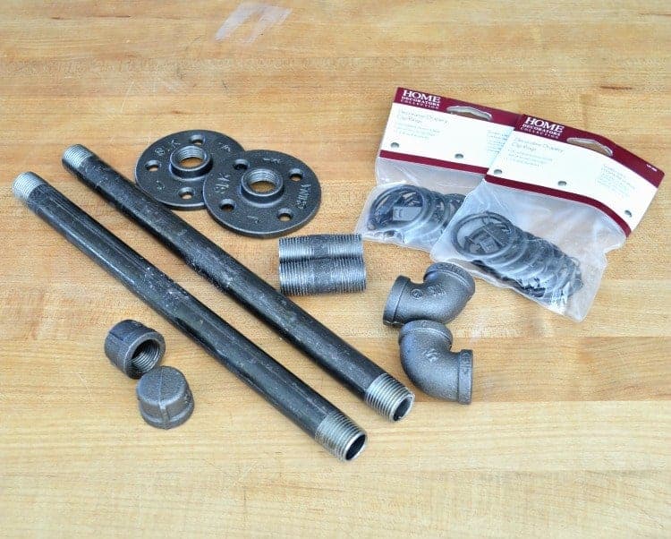 Easy DIY Curtain Rods picture The supplies needed to make DIY custom curtain rods, black pipe and curtain clips