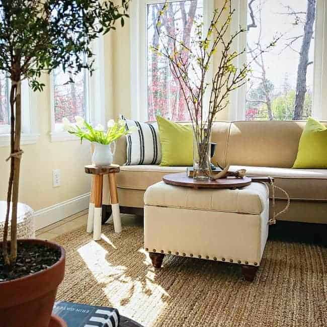 A natural fiber area rug adds texture and warmth to a sunroom, plus it's an inexpensive choice compared to wool rugs.