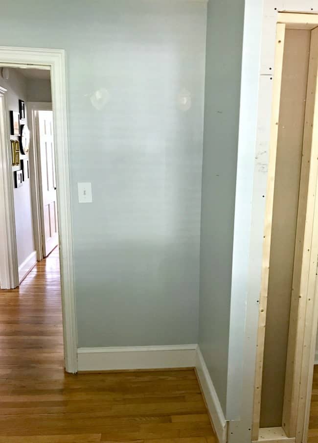 empty corner with blue painted walls in guest bedroom