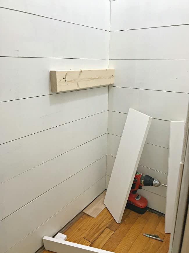 Adding wood planks in a powder room.