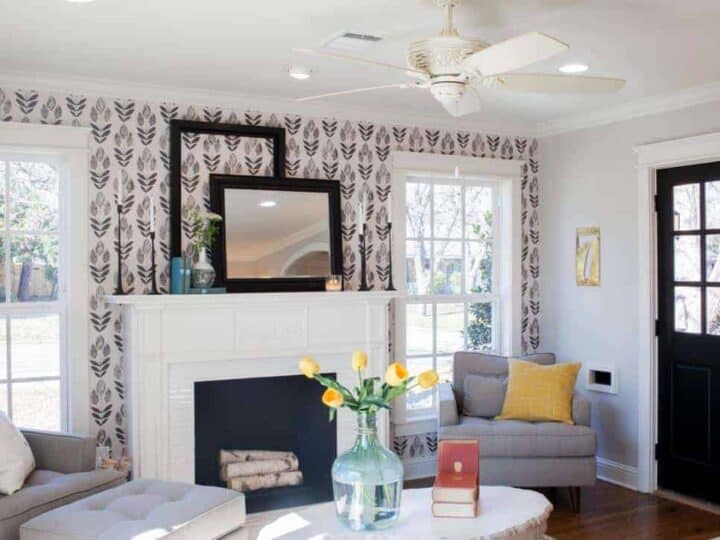 Farmhouse living room with wallpaper on the fireplace wall.