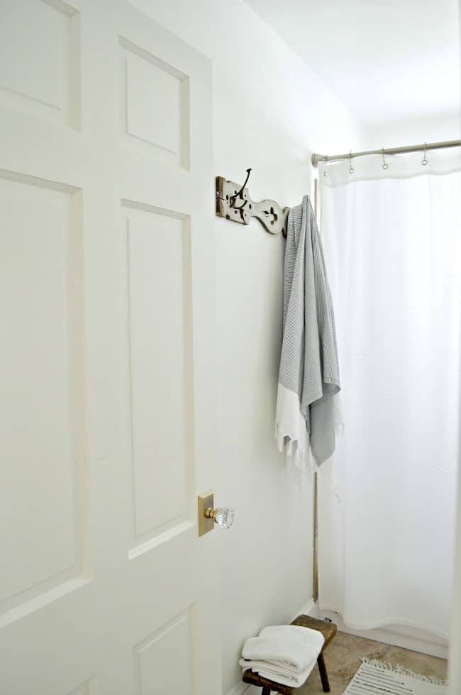 diy bathroom towel rack with a striped towel hanging on it