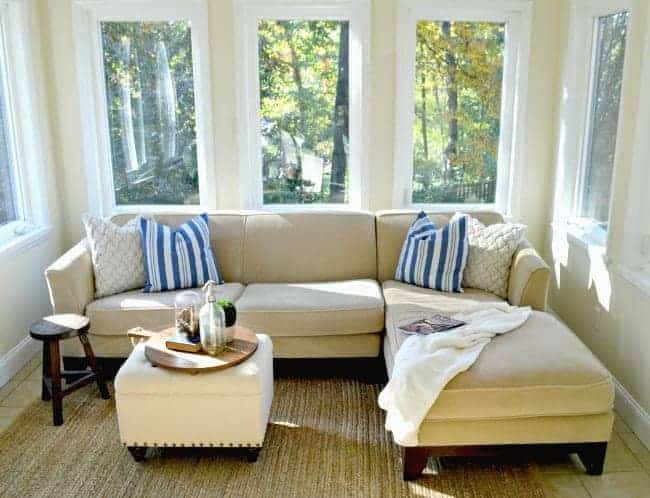 Yellow walls and sectional sofa in the sunroom addition.