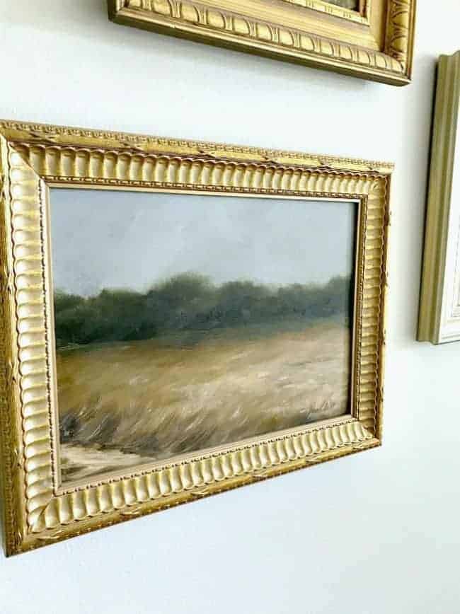 How to use thrift store art to make a gallery wall in a master bedroom. 