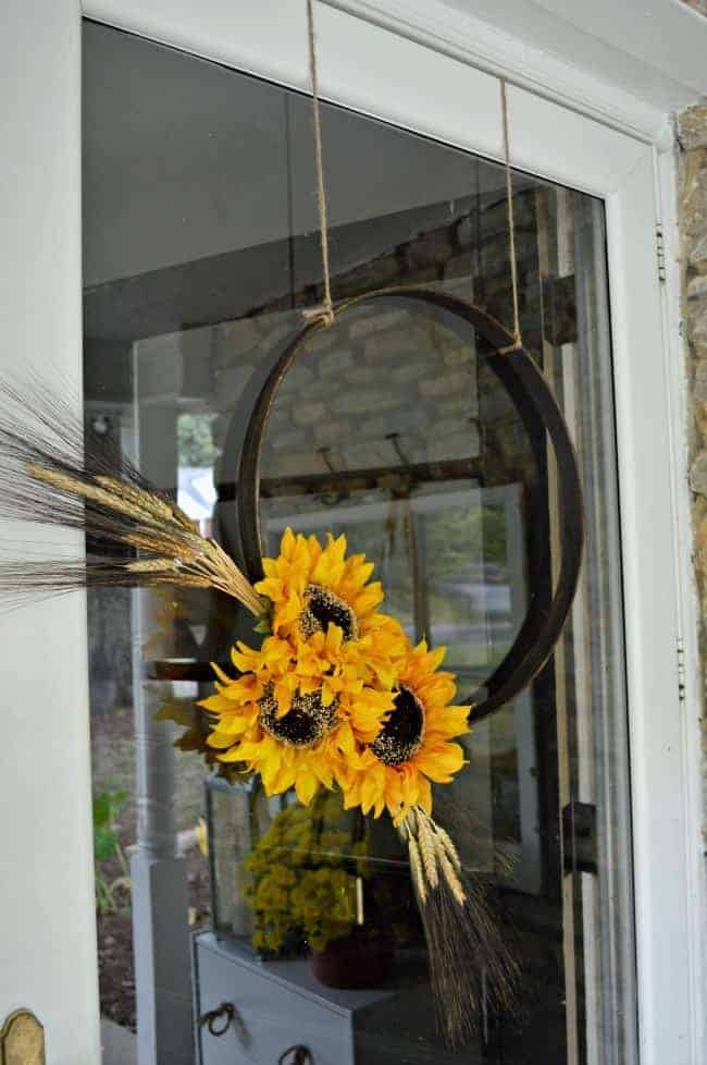 closeup of simple fall hoop wreath hanging on a front door