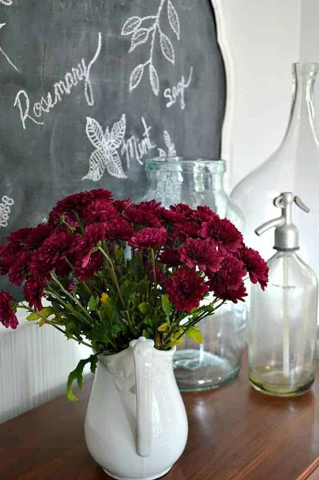 mums in white pitcher