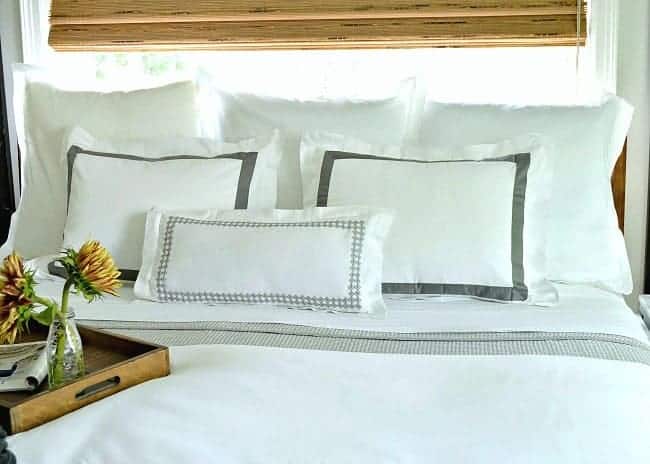 5 tips to create a cozy bedroom for fall, including using lots of pillows. 