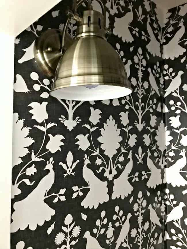 light hanging in small closet with wallpaper