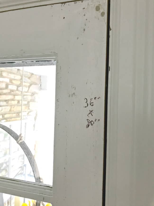 door dimensions written in ink on old front door
