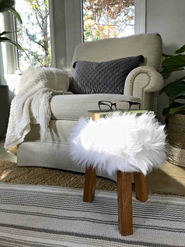 glasses sitting on a small stool with faux fur thrifty decor idea 