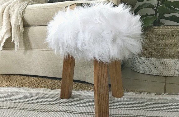 DIY faux fur stool on striped rug