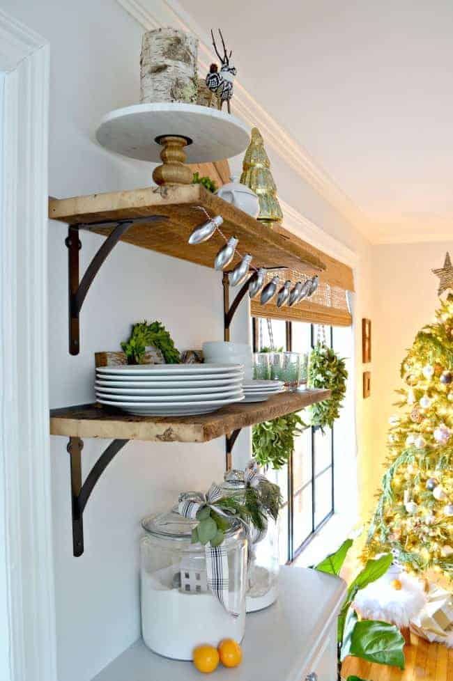 How to create a cozy cottage Christmas kitchen by using farmhouse touches like tons of fresh greenery from the yard.