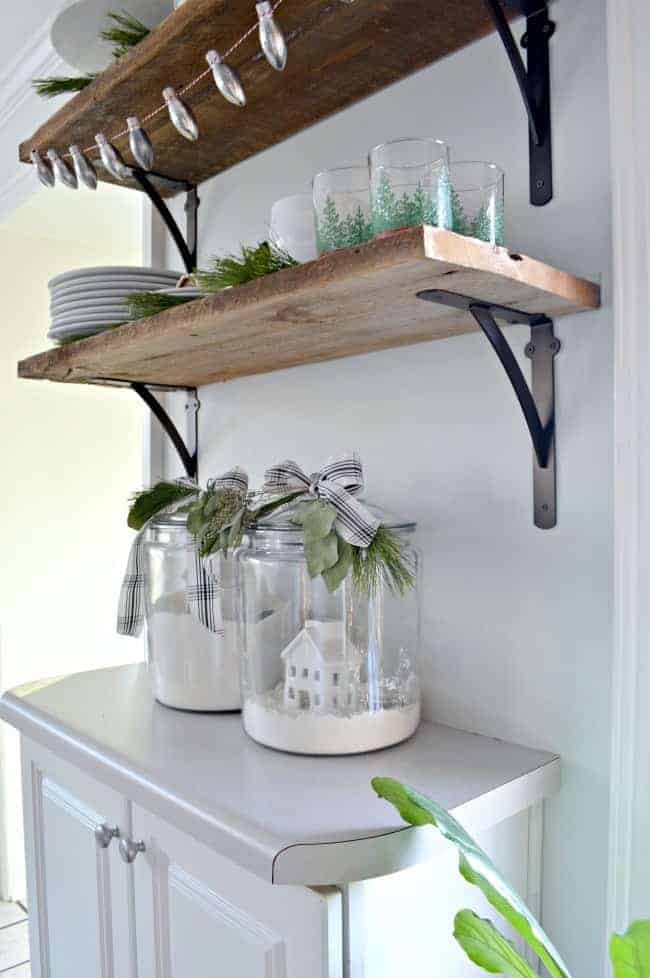 How to create a cozy cottage Christmas kitchen by using farmhouse touches like fresh greenery and decor you already have.