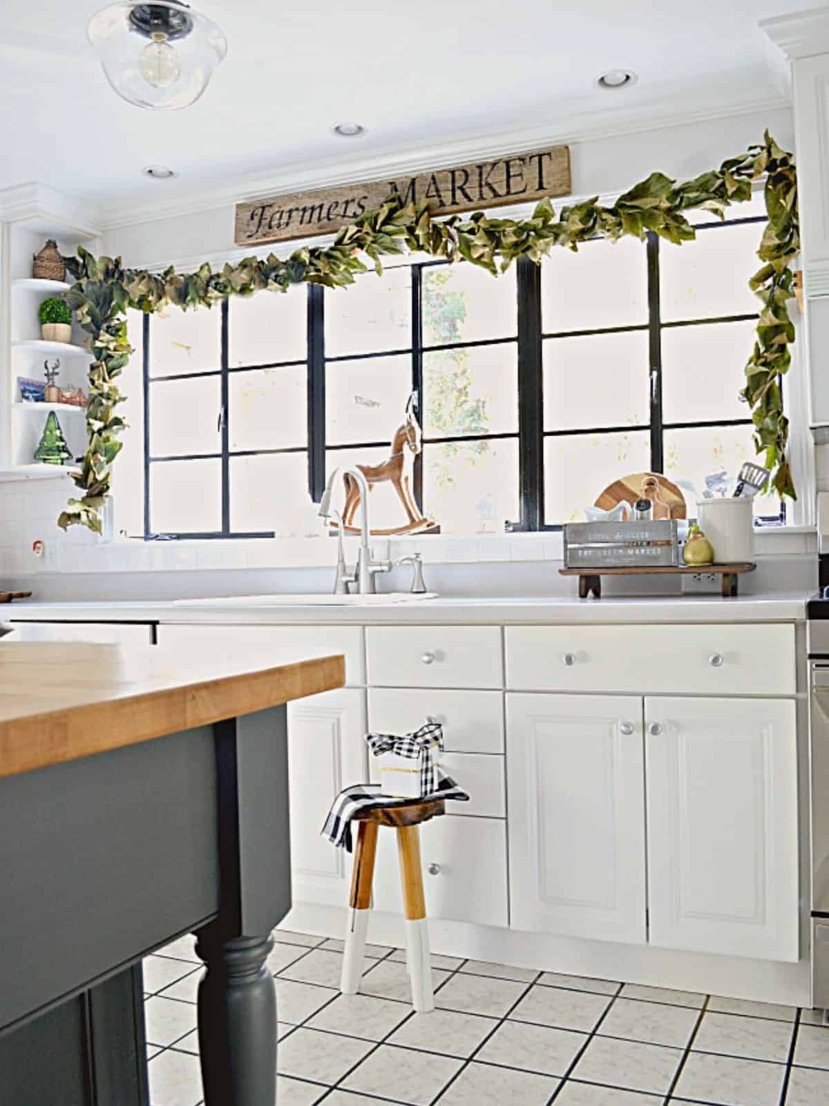 DIY Magnolia Leaf Garland image magnolia leaf garland hanging on kitchen window